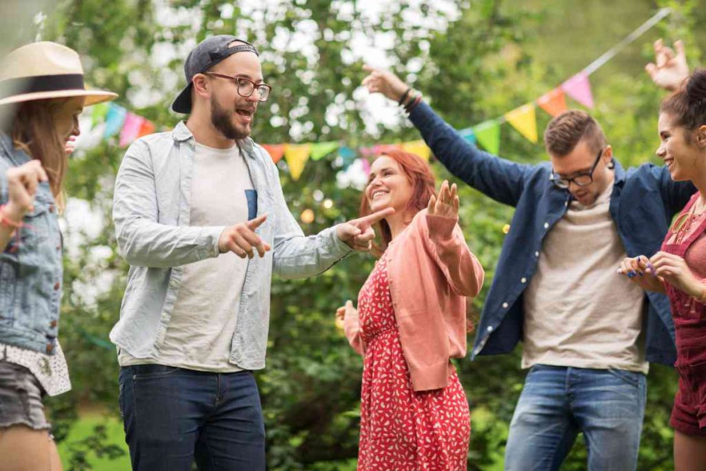 Family outside having a dance party at a reunion.